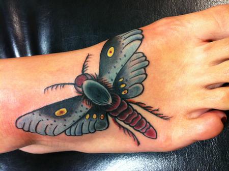 Mike Riedl - colorful moth tattoo on the foot