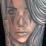 Realistic black and gray girl with gun portrait tattoo. Scott Grosjean Art Junkies Tattoo. Tattoo Thumbnail