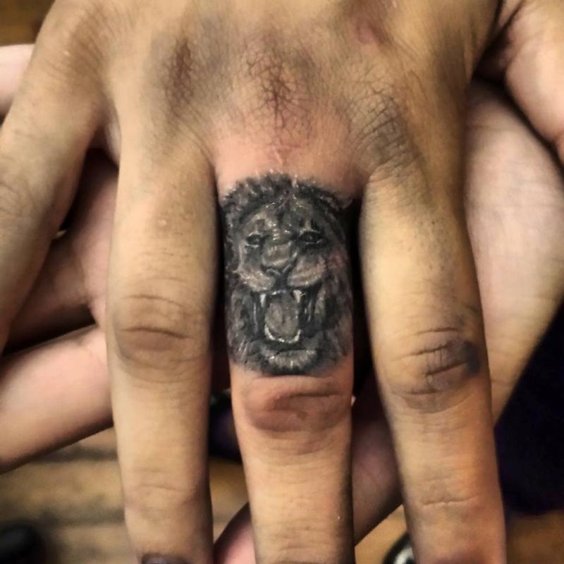 lion finger tattoo by Haley Adams Tattoos