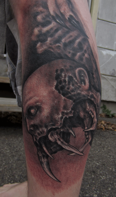 black and grey leg tattoo