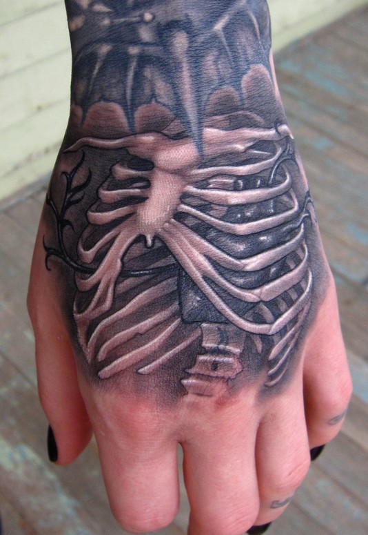skeleton rib cage hand tattoo by Scotty Munster: TattooNOW
