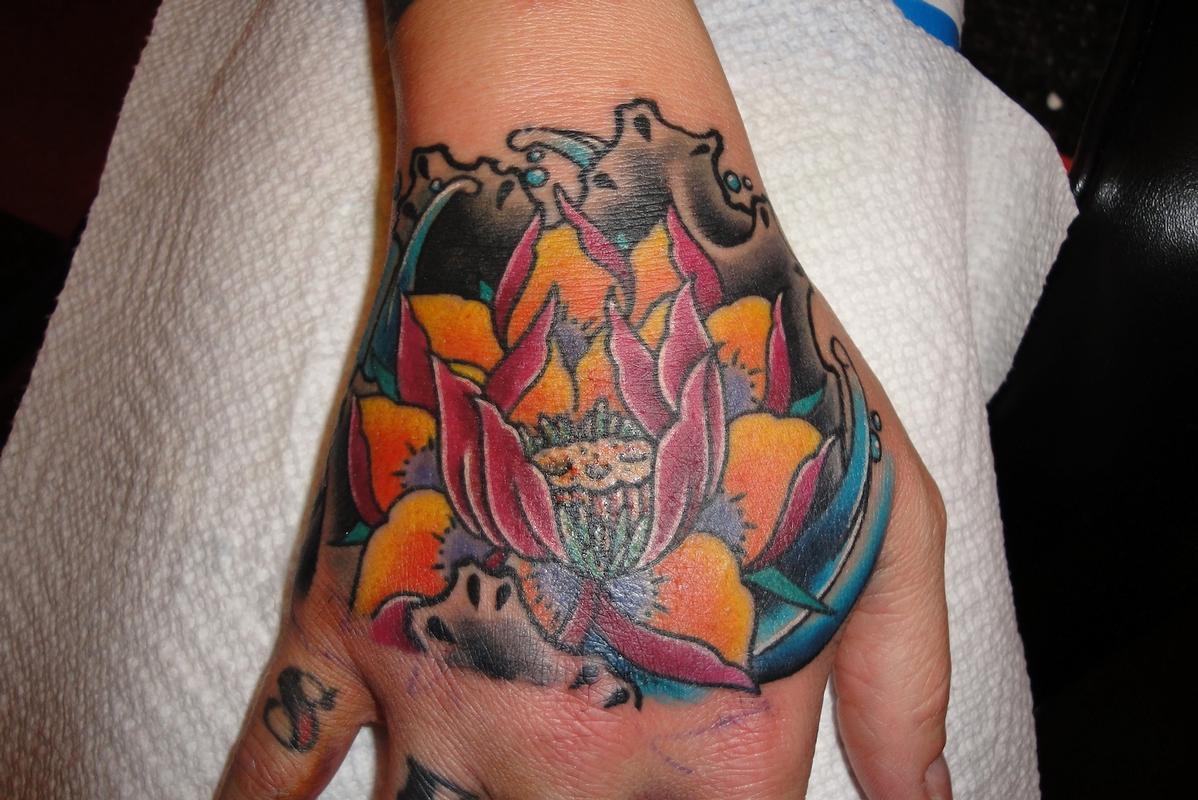 Lotus Flower Hand Tattoo by KR Rossi: TattooNOW
