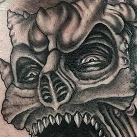 demon faces in smoke tattoo